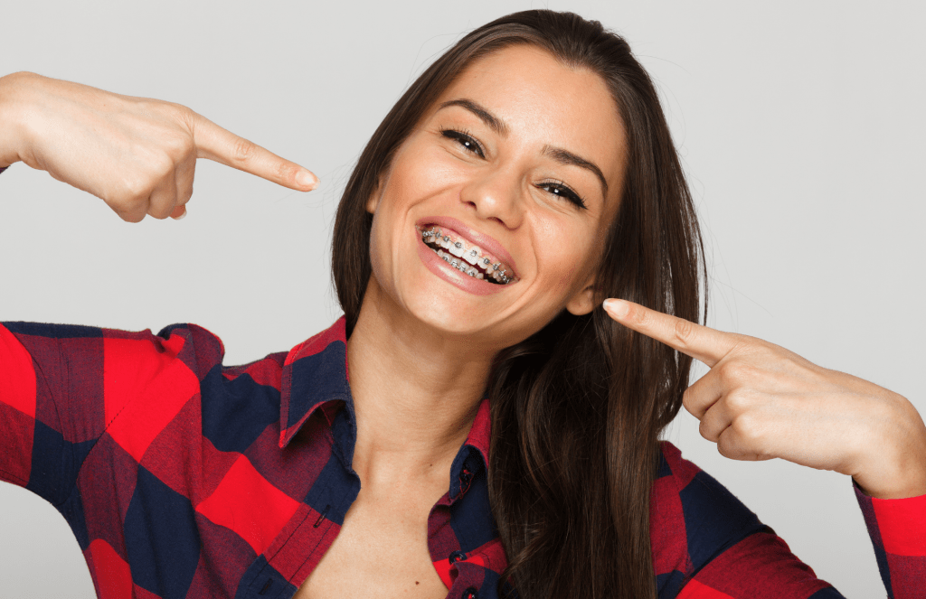 woman pointing at her braces