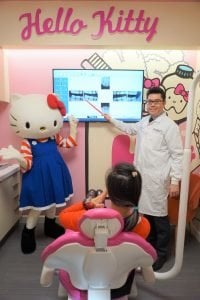 Dentist and Hello Kitty at a doctor examination looking at x-rays