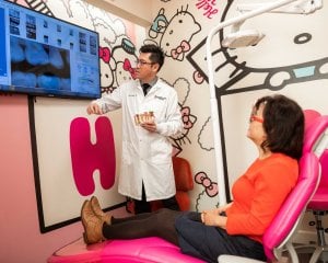 General Doctor reviewing Cavity with Adult Dental Patient