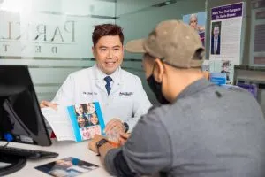Cosmetic Dentist in Arcadia showing Invisalign for smile makeover consultation with male adult patient