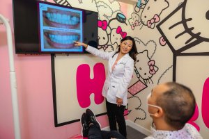 Cosmetic dentist with adult dental patient about smile makeover consultation