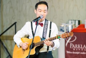 General and Cosmetic Dentist playing guitar at dental christmas party