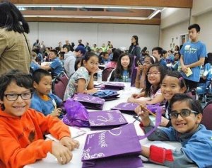 Sharing goodie bags to pediatric students in local elementary school from Parklane Dental