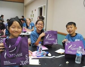 Sharing goodie bags to pediatric students in local elementary school with a dental visit from Parklane Dental