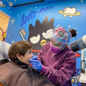 Pediatric Patient visiting Badtz-Maru Dental Room with Dental Assistant