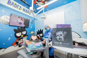 Dental Hygienist cleaning adult female patient for preventive dentistry at Badtz-Maru Themed Room in Parklane Dental in Temple City