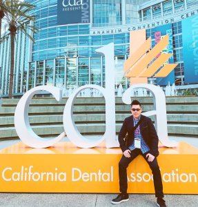 Cosmetic dentist Dr. Eric To in front of California Dental Association convention