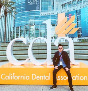 Cosmetic dentist Dr. Eric To in front of California Dental Association convention