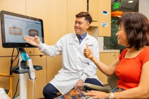 Cosmetic dentist with adult female patient for dental exam and Invisalign consultation at Parklane Dental in Arcadia, California