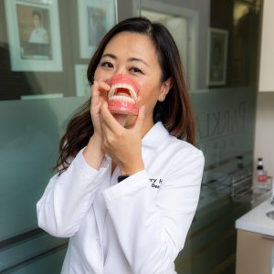 General and cosmetic dentist review gum health instructions in a dental oreatory room