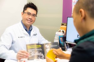Cosmetic dentist with adult male patient reviewing the smile benefits from Invisalign treatment at Parklane Dental in Temple City, California